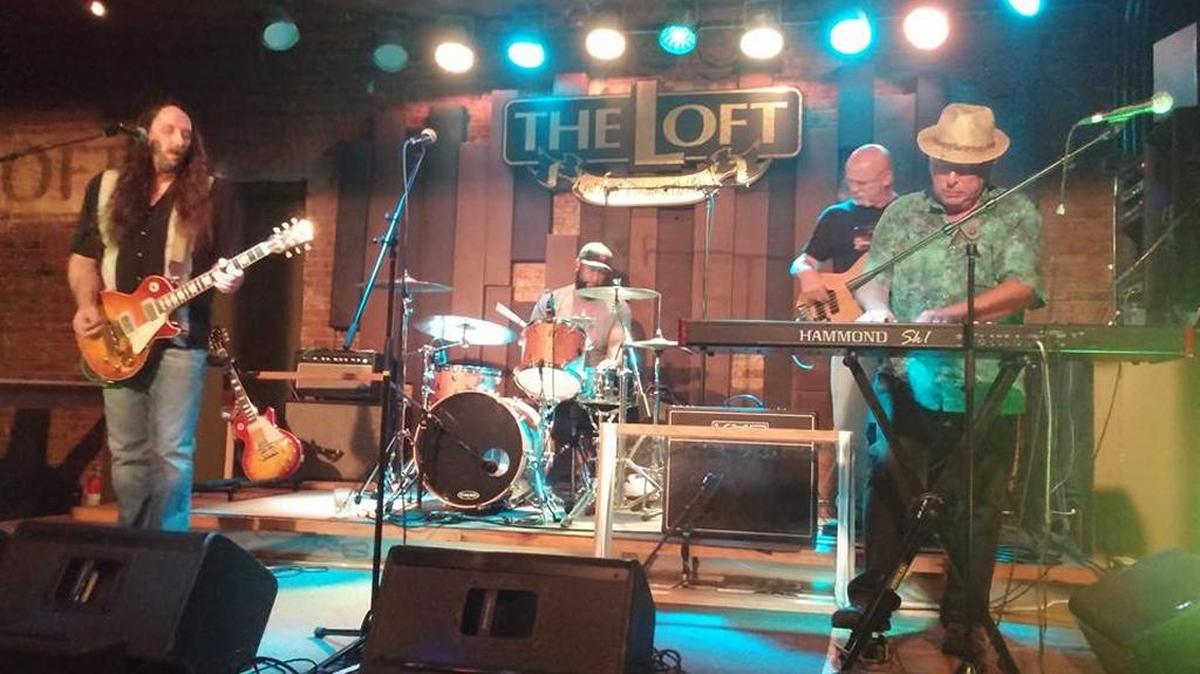 A local band performs at The Loft during a blues night.
