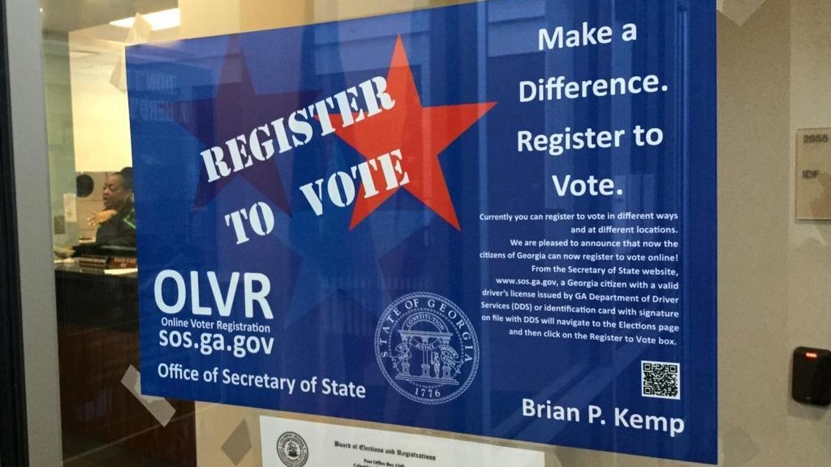 A sign at the door to the Muscogee County Elections and Registration Office urges residents to register to vote in 2018.