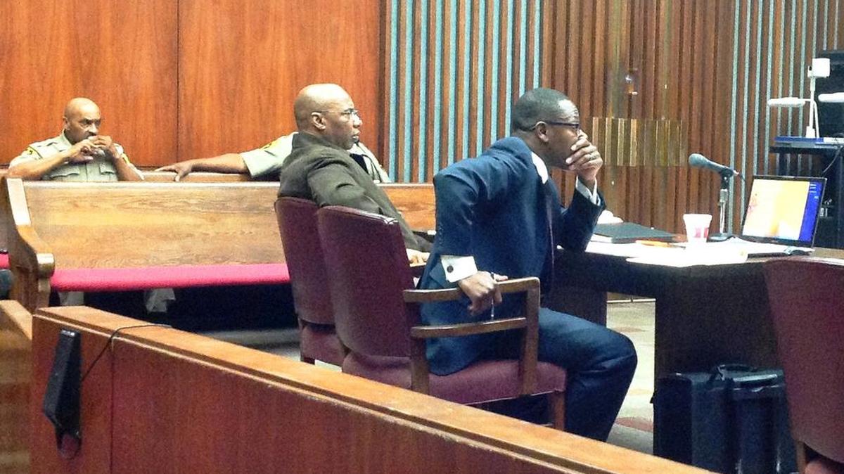 Vince Harris and attorney Stacey Jackson listen to testimony in Harris’ double-murder trial.