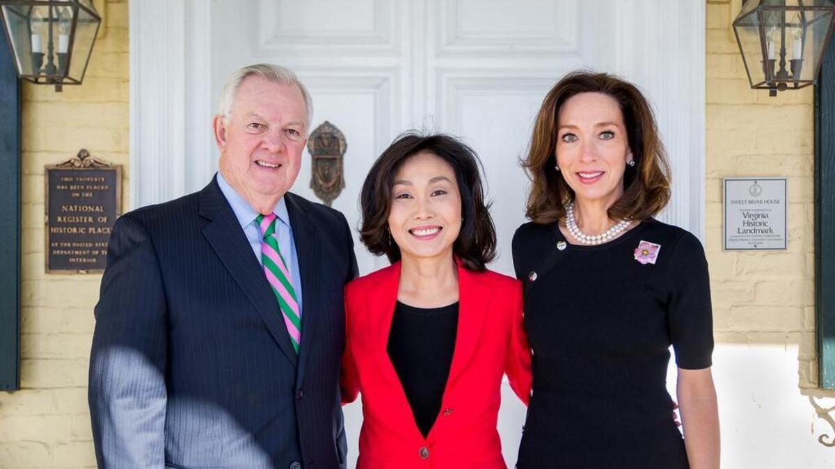 From left, current Sweet Briar President Phillip C. Stone, President-elect Meredith Woo and Sweet Briar Board Chairwoman Teresa Tomlinson take photos in Virginia on Monday at an event announcing Woo’s appointment as president.
