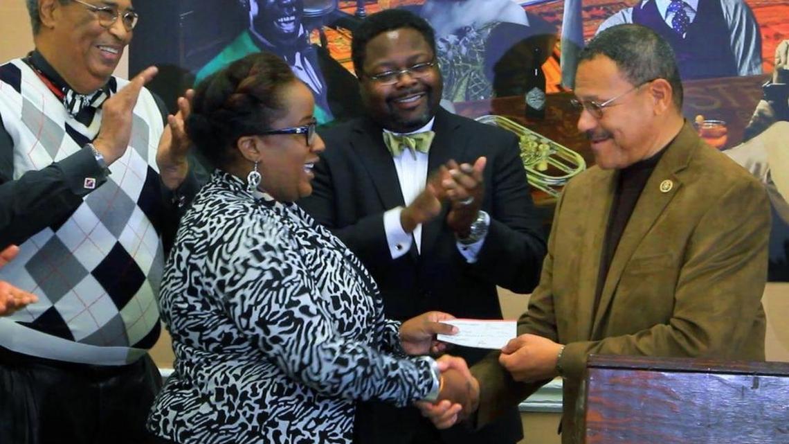 Congressman Sanford Bishop,right, presents a check for $7,000 to Shae Anderson, managing director of The Liberty Theatre & Cultural Center, Tuesday morning as Robert Anderson, far left, and Teddy Reese look on. The grant comes from proceeds from the annual Black History Observance Breakfast, which benefits local non-profit organizations in the community.