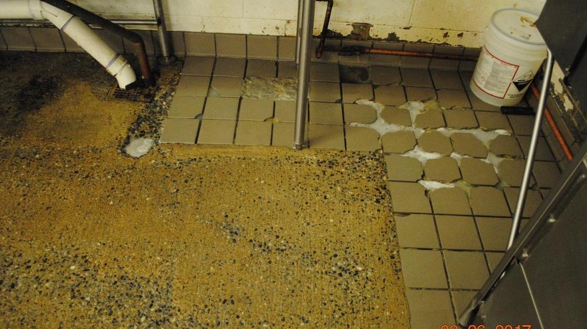 The tile floor in the kitchen at the Muscogee County Jail is both a safety hazard and in violation of health codes, according to city officials. The floor is cracked/chipped, missing grout, and has areas of pooling with standing water and continues to deteriorate.