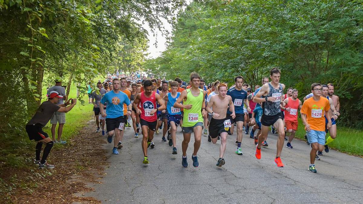 Runners take off from the starting line at Lake Oliver Marina for the Big Dog Heatwave 5 mile run Saturday.
