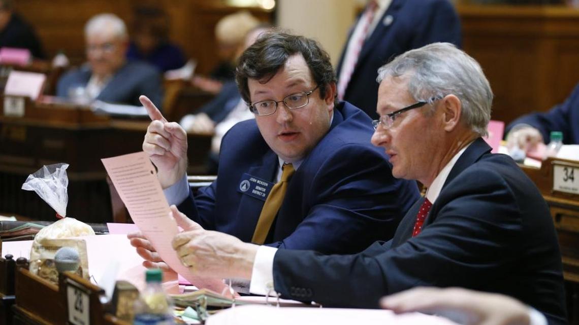 Sen. Josh McKoon, R-Columbus, center, talks with Sen. Mike Crane, R-Newnan, on the Senate floor during the final day of the general assembly Thursday at the Capitol in Atlanta.