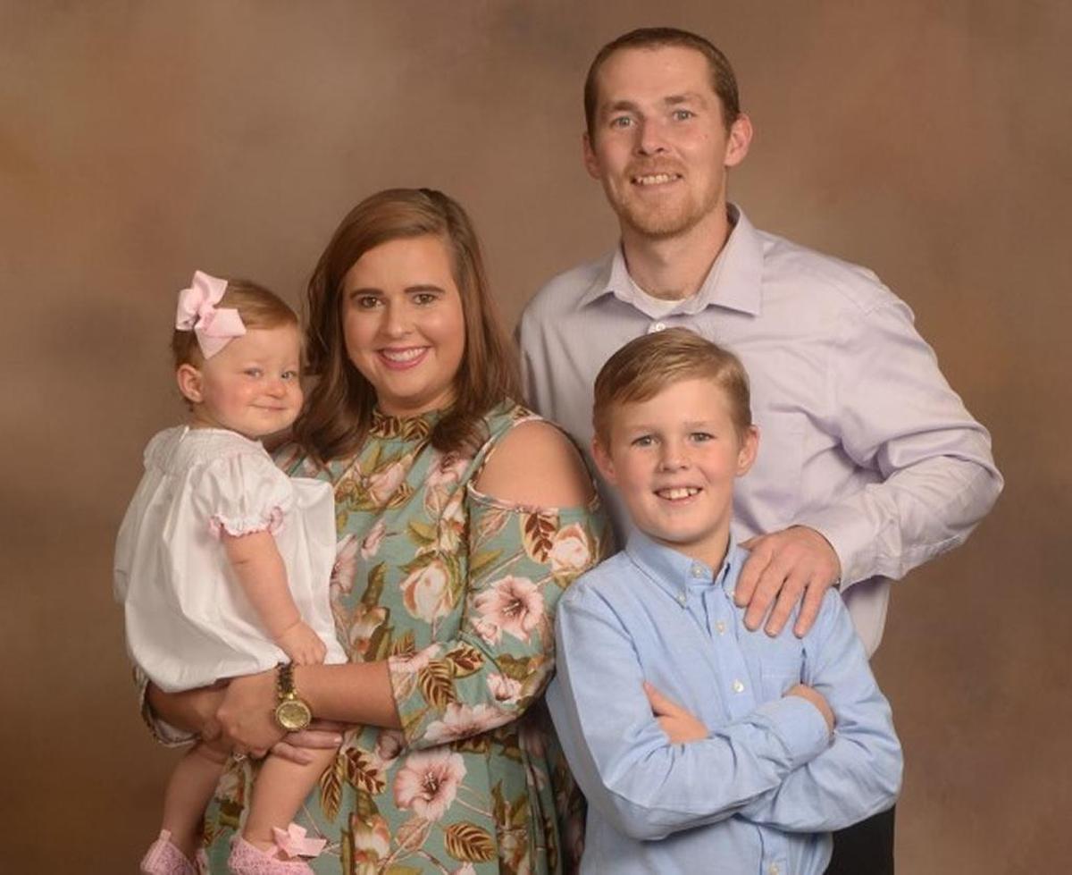 Melanie and Steven Gouine pose with their children, 1-year-old Chloe and 12-year-old Christian, in this family portrait.