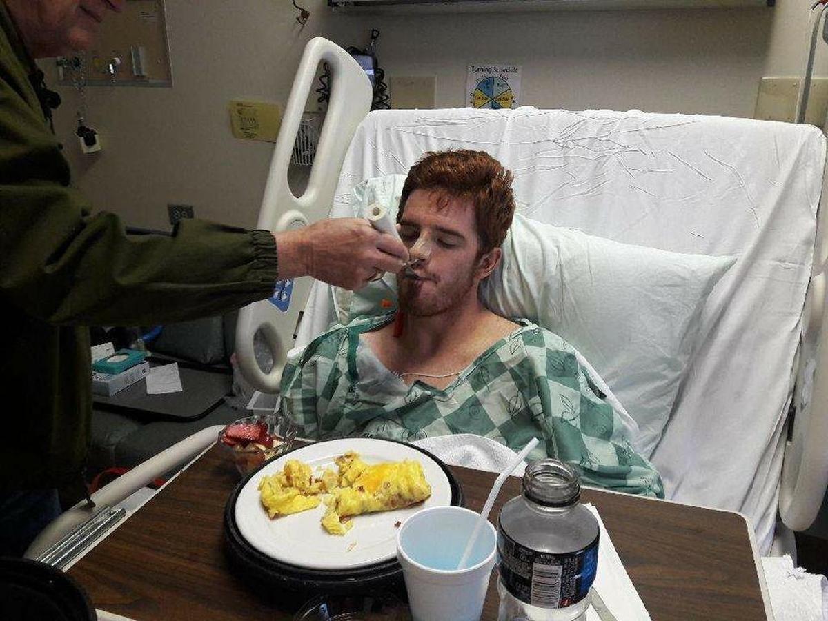 Evan eating solid food for the first time since his medical emergency.