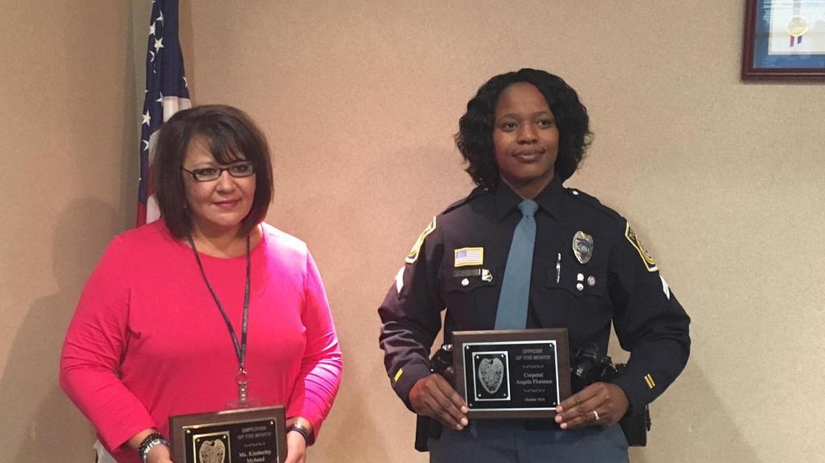 Kimberley Myhand, at left, and Cpl. Angela Florence with honors during a Nov. 4 ceremony at the Public Safety Center.