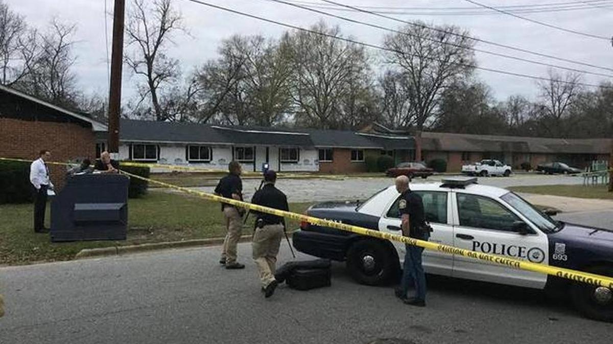 Police technicians use scanning equipment at the scene of deadly shooting at 339 32nd Ave. in Columbus on Thursday.