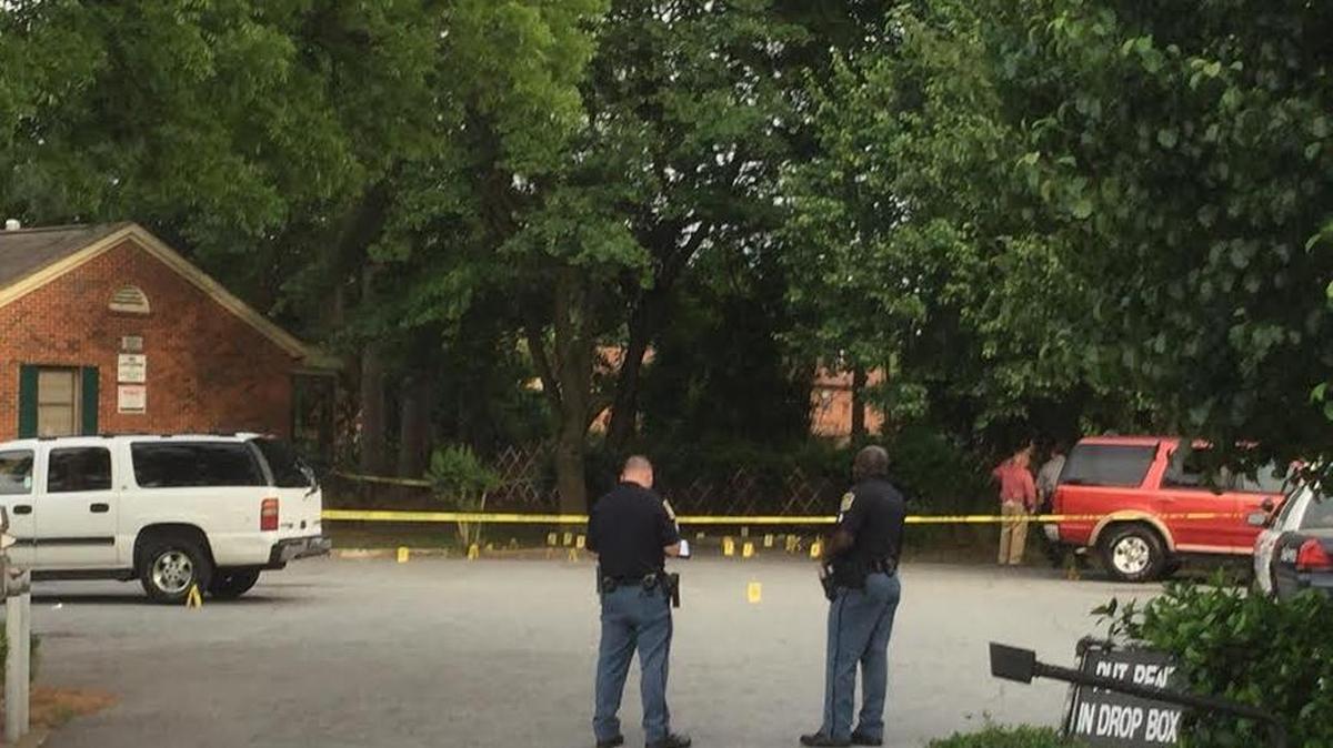 The parking lot near the 301 Building of Warren Williams Homes was dotted with evidence markers after a man was shot to death Saturday afternoon.