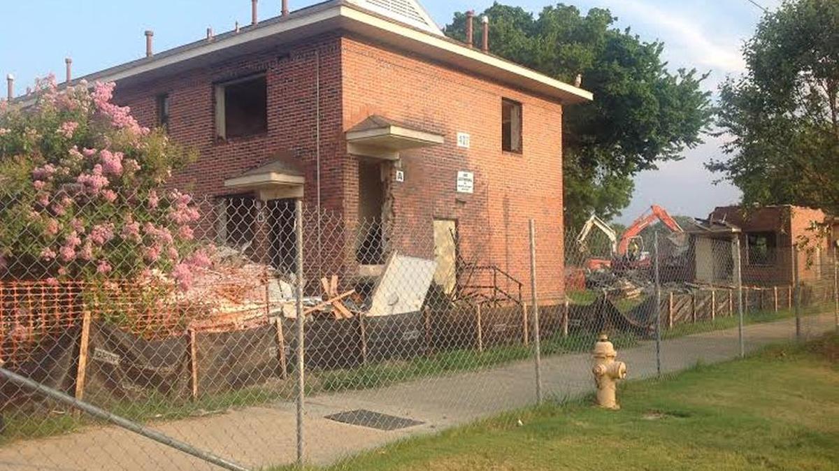 Demolition crews worked Tuesday morning to take down the final structures at Booker T. Washington public housing complex.