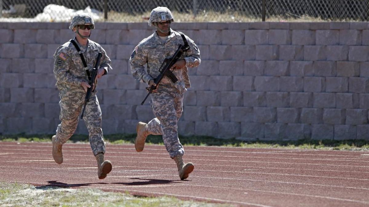 Two soldiers start a 400-meter run in full combat gear as they demonstrate the Army's new Combat Readiness Test, at Fort Jackson, in Columbia, S.C., Tuesday, March 1, 2011.