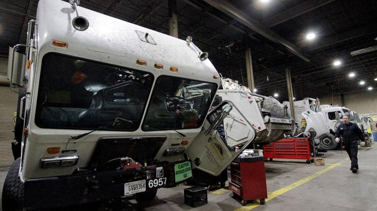 Fleet maintenance technician David Brady walks down the aisle of city garbage trucks at the City Garage Wednesdsay. The aging fleet is a safety hazard to the city's drivers and other motorists on the road, according to both the drivers and the mechanics who work to keep the trucks maintained.