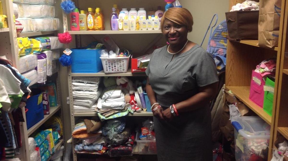 Jena Jones, interim county director for the Muscogee County Department of Family and Children Services, stands in a closet filled with clothes and toiletries donated by local churches and other organizations for children served by the agency.