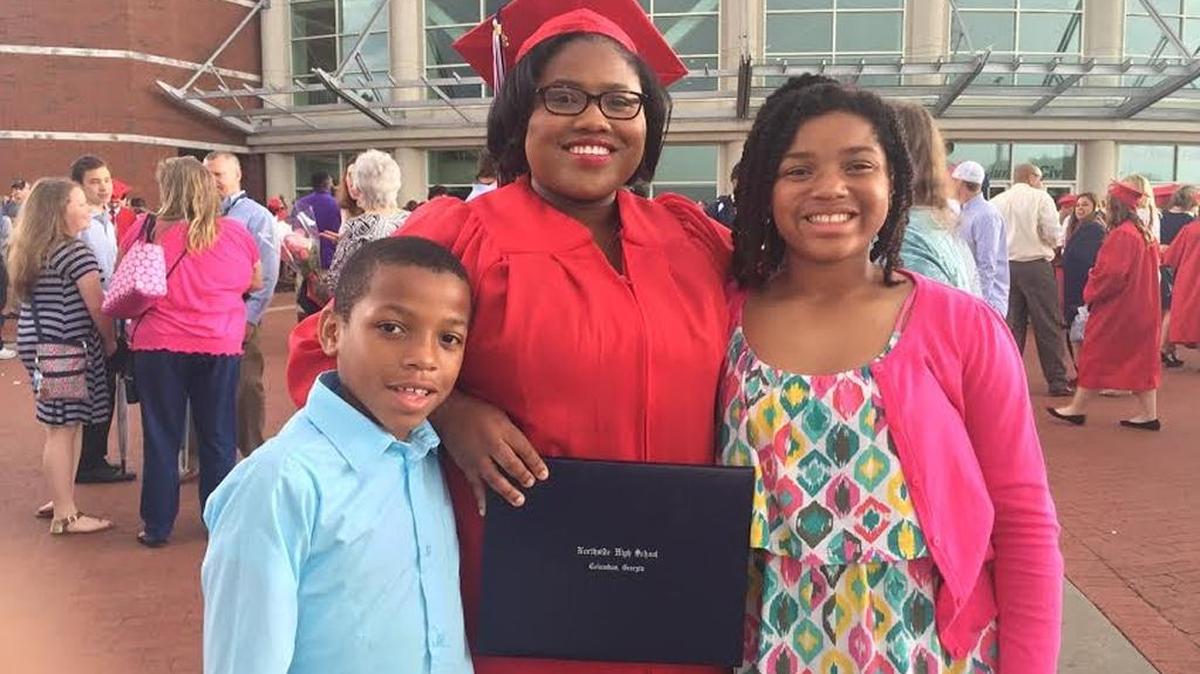 Collins Nelson, 17, celebrates with her brother, Jason, and sister, Christian, at the Columbus Civic Center, after graduating from Northside High School last week. She participated in the state’s Move On When Ready Program, which allowed her to earn 25 credits at Columbus State University while still in high school.
