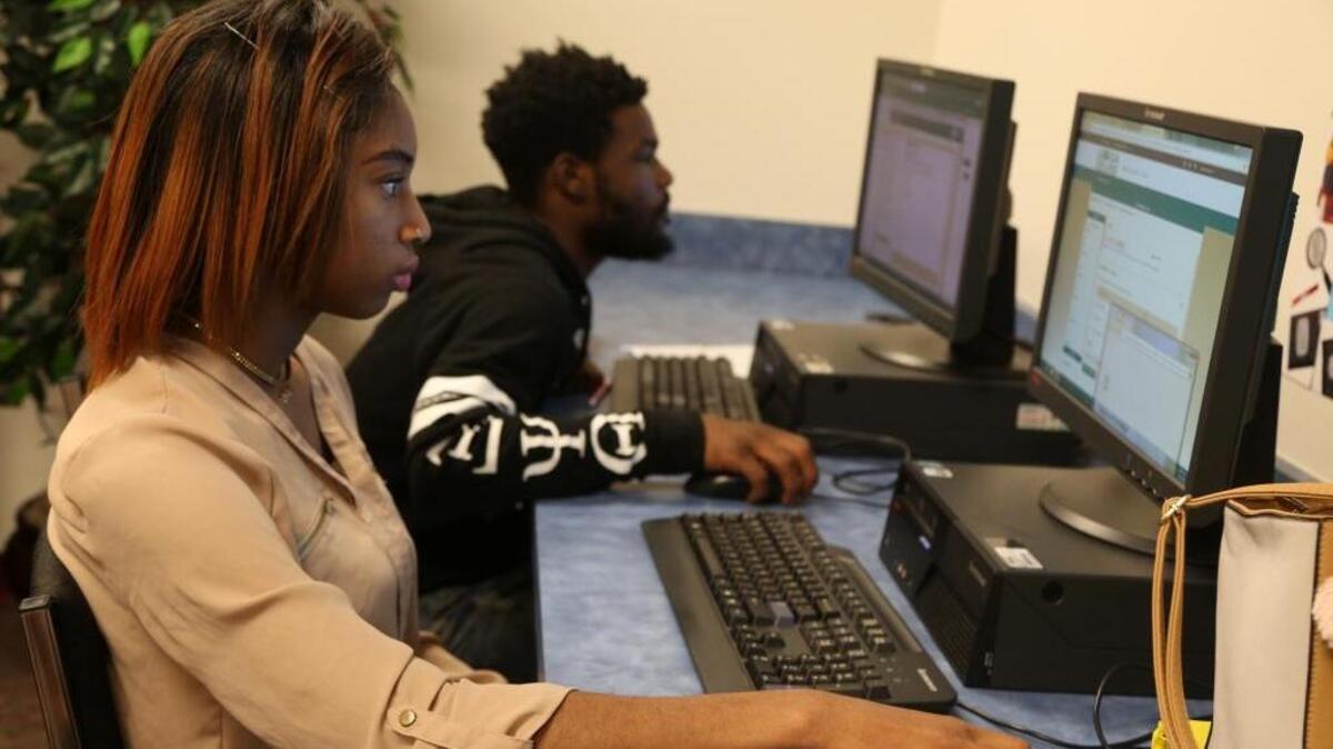 Alencia Sims and Johnny McPherson, two students at Carver High School, participate Monday in the school’s Academic Recovery program, which school officials say has helped Carver improve its graduation rate by double digits in each of the past two years.