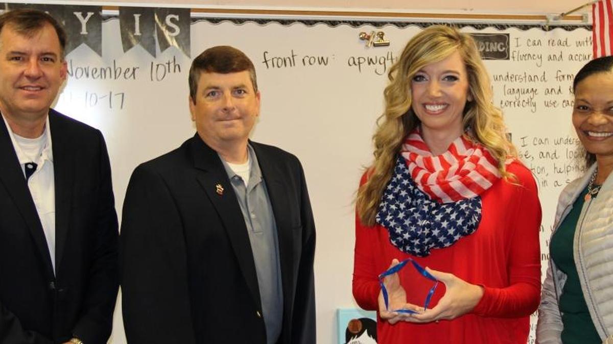 From left, Harris County School District superintendent Jimmy Martin, board member Garnett Ray III, HCSD 2017-18 Teacher of the Year Maggie Williamson of New Mountain Hill Elementary School and board member Monica Sparks pose for a photo after Williamson is presented her award.