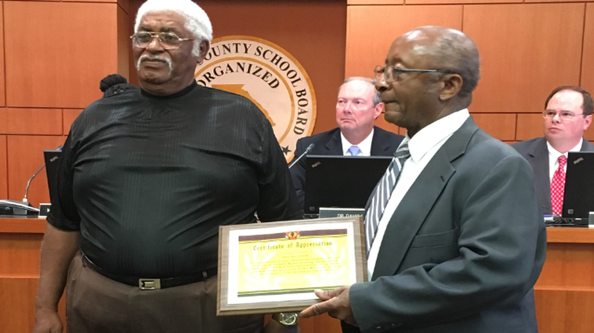 Muscogee County School District bus driver Odis Hailstock, left, is honored May 15, 2017, during the Muscogee County School Board meeting for saving a third-grader from choking April 26. MCSD assistant transportation director Willie Brown holds the certificate of appreciation. In the background are MCSD superintendent David Lewis, left, and MCSD attorney Greg Ellington of the law firm Hall Booth Smith.