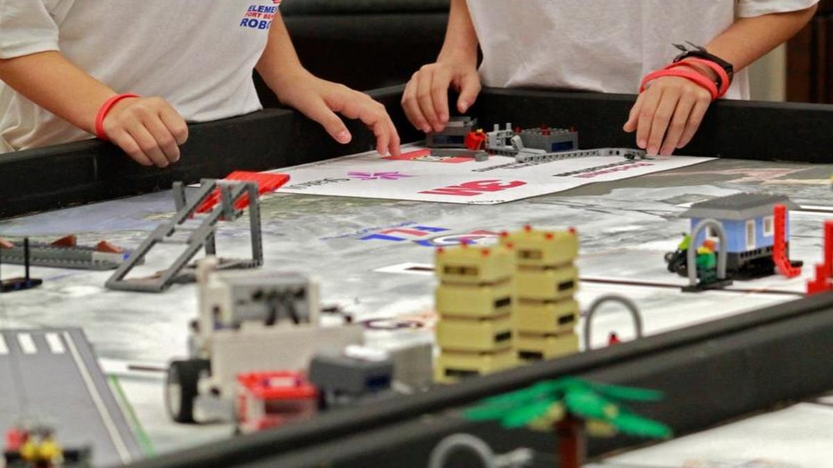 In this file photo from Nov. 23, 2013, Josephine Blackham, left, and Micah Ramirez, students at Fort Benning's Dexter Elementary School, watch as their robot navigates the obstacle course during the FIRST LEGO League regional tournament at Columbus State University.