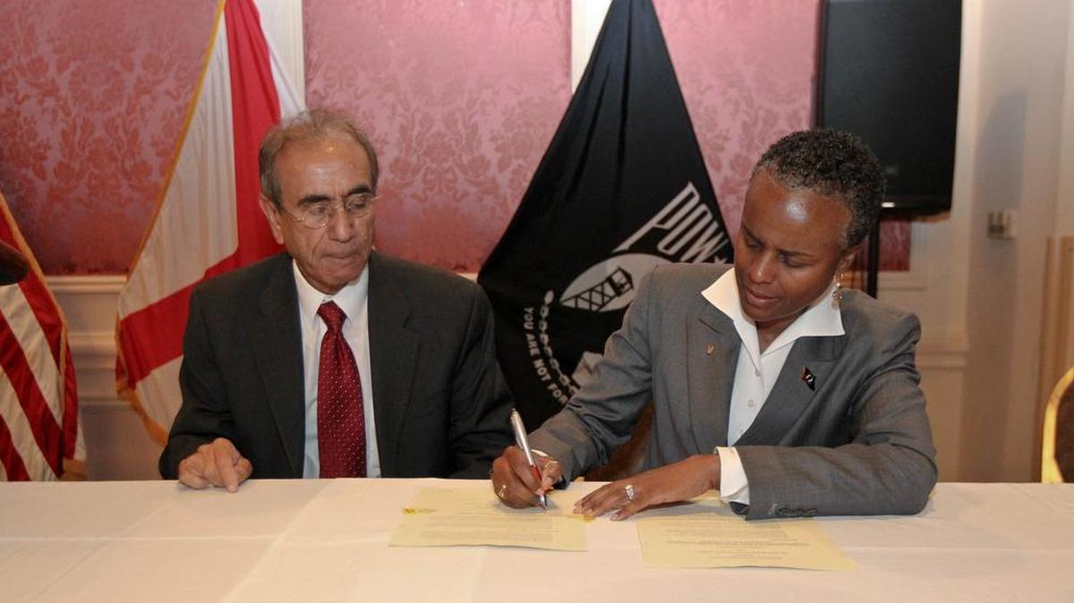 Provost Tejiner Sara, DPAA’s Fern Wimbush sign agreement