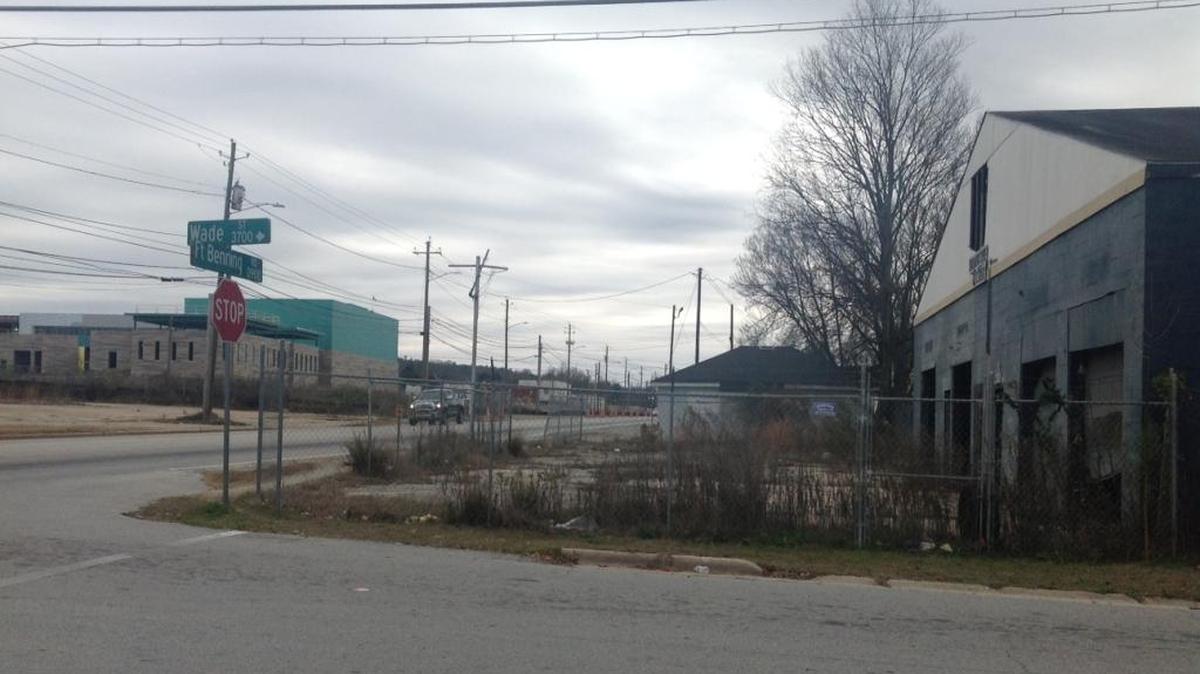 This business at right no longer operates at Wade Street and Fort Benning Road where litter collects inside the fence. Down the road is the $56 million construction of Spencer High School.