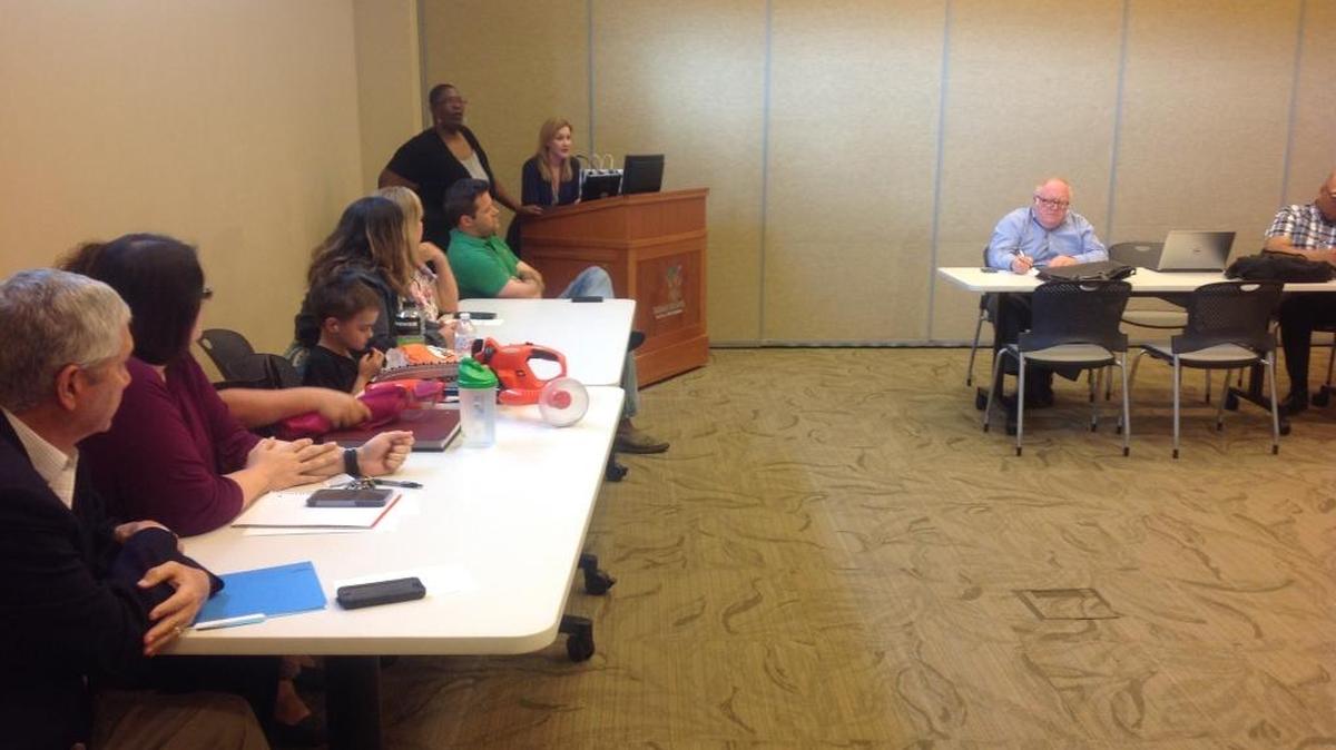 Marianne Young, with Waleisah Wilson beside her at the podium, introduces the public forum for parents to discuss alternative education in the Muscogee County School District. Wilson and Young organized the forum Monday evening in the Synovus Room at the Columbus Public Library.