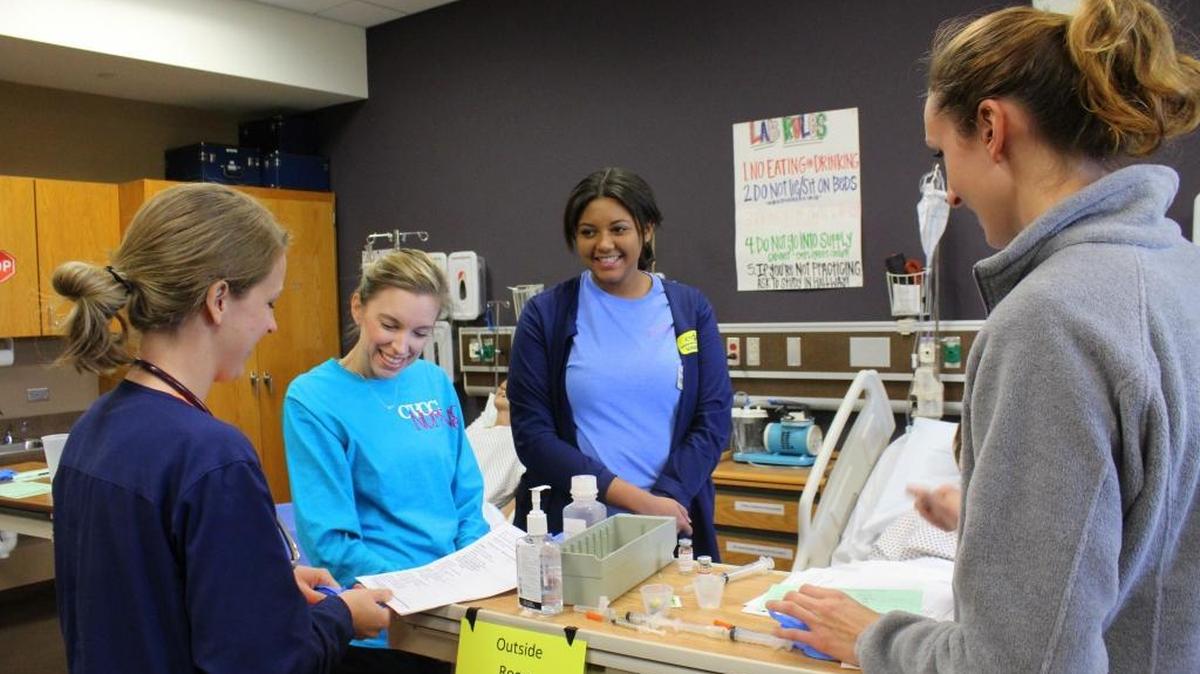 Chattahoochee Valley Community College nursing instructor Marquette Brewer teaches first-year nursing students Brittany Keene, Ellyssa Aster and Erin Engelhardt during lab time.