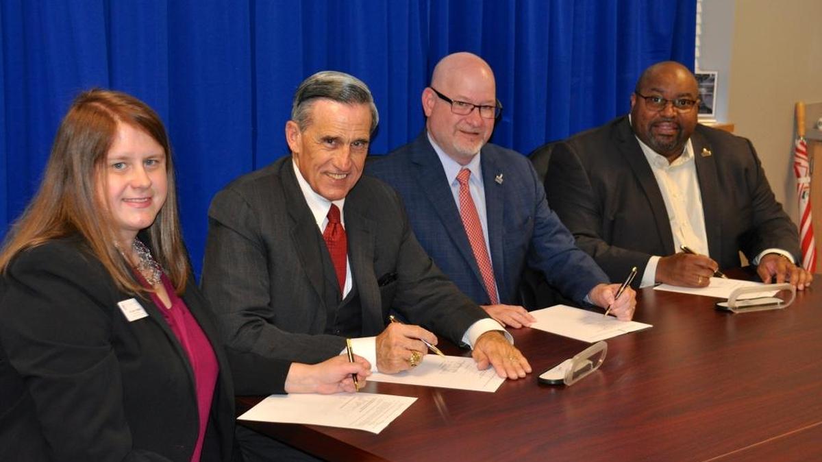 Columbus State University officials have signed an articulation agreement with the Edward Via College of Osteopathic Medicine that guarantees admission into VCOM’s Doctor of Osteopathic Medicine program for five CSU students annually. Pictured at the signing ceremony Tuesday are, from left: Kathleen Hughes, director of CSU's Premedical Studies program; John Rocovich, VCOM chairman of the board; Chris Markwood, CSU president; Dennis Rome, dean of CSU's College of Letters and Sciences.