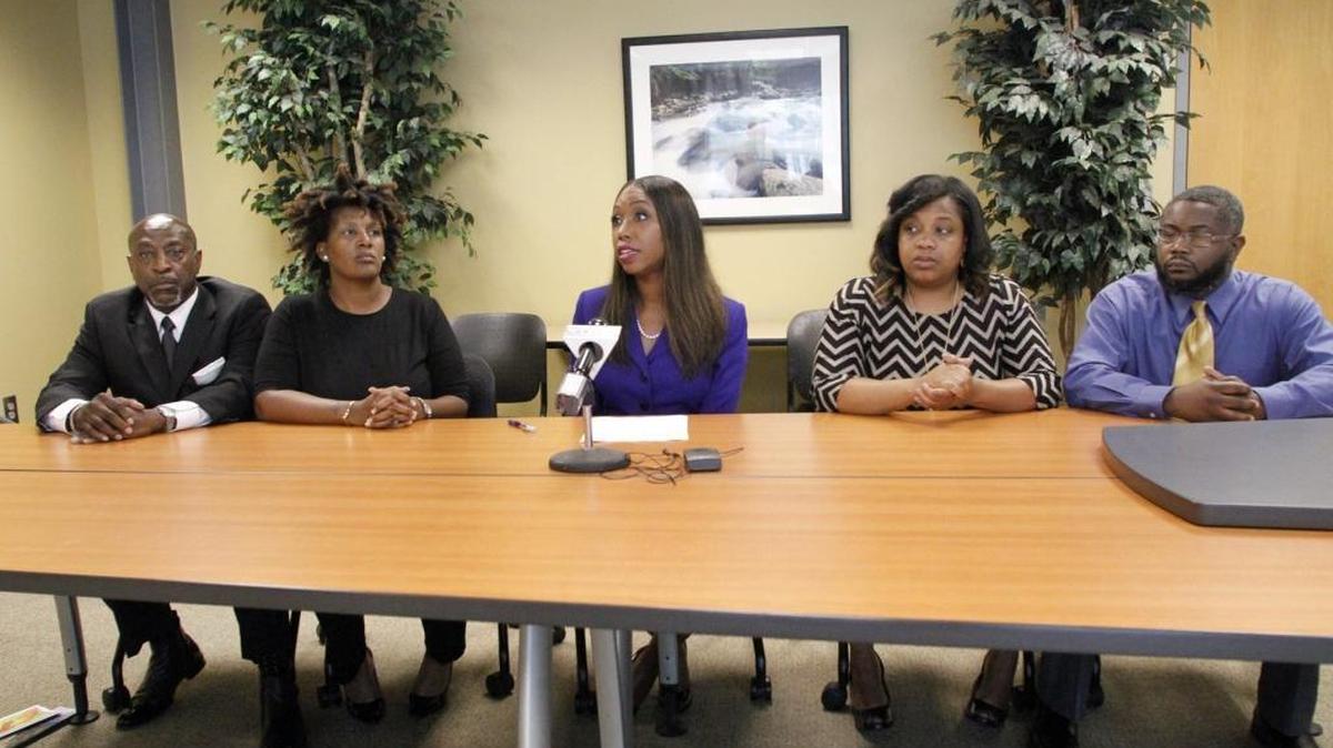 Attorney Katonga Wright, center, holds a press conference with the parents of two Reese Road Leadership Academy students whose fourth-grade teacher used racial slurs in the classroom. The parents are calling for the Muscogee County School District to terminate the teacher's employment. From left: Kenneth and Shunale Harley, and Equisha and Nathan Frazier.