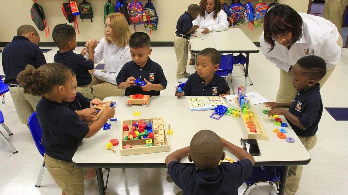 Teachers at the Emanuel Preparatory School of Math and Science work with the school's first class of students in this August 2016 file photo.