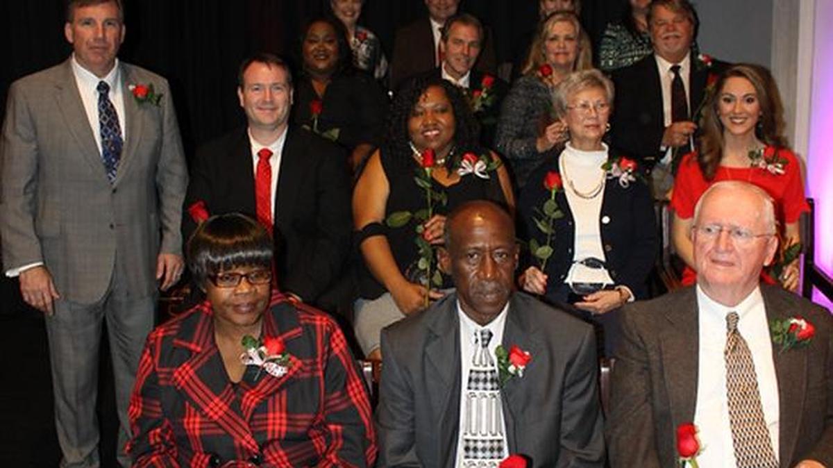 Phenix City Schools superintendent Randy Wilkes, standing at left, poses with the 2016 Heart of the Community award winners at last year’s event.