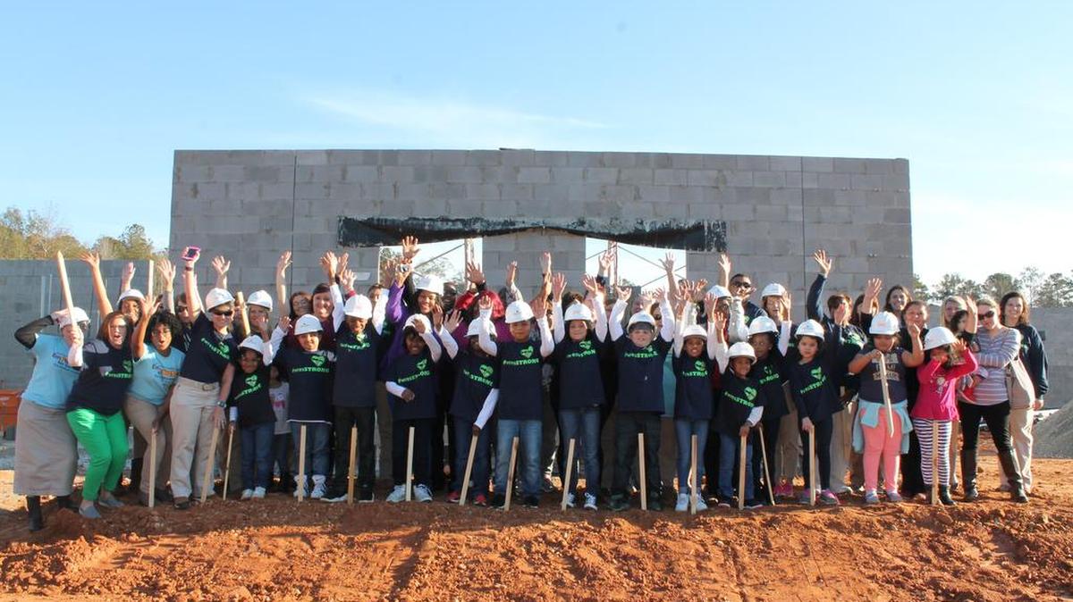 Whitesville Road Elementary School students, parents and staff put stakes in the ground at the construction site of their new elementary school during Thursday’s ceremony.