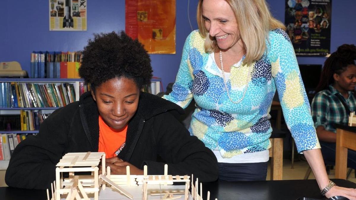 Arnold Magnet Academy eighth-grade physical science teacher Melissa Niemi works with a student.