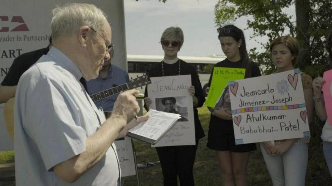 The Rev. James H. Purks, III, speaks on May 27 at a vigil outside of the Stewart Detention Center in Lumpkin, Ga., in response to the death of Jean Jimenez-Joseph who died in ICE custody. The event was organized by Georgia Detention Watch and concerned community members, including Marta Lopez, the girlfriend of Shaw High grad Jose Gonzalez Ochoa detained at the facility since mid-April. In the photo, Lopez holds a yellow placard.