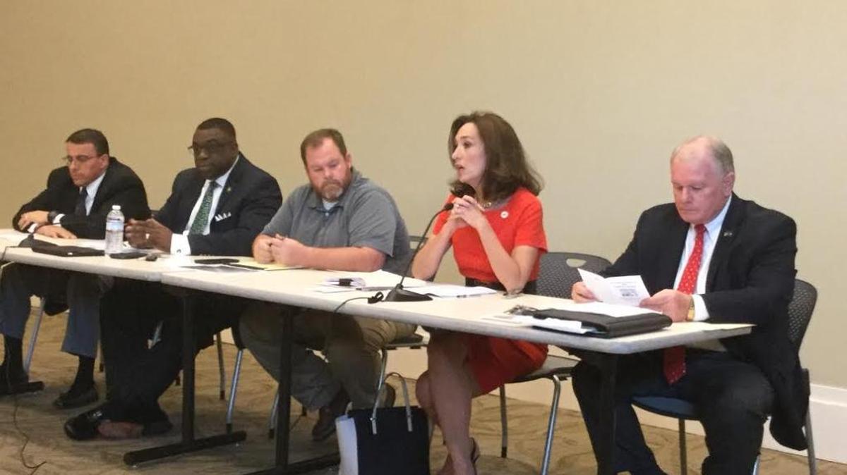 From left, Sheriff John Darr, Marshal Greg Countryman, Crime Prevention Director Seth Brown, Mayor Teresa Tomlinson and Police Chief Ricky Boren take part in forum Thurday on policing at the Columbus Public Library.