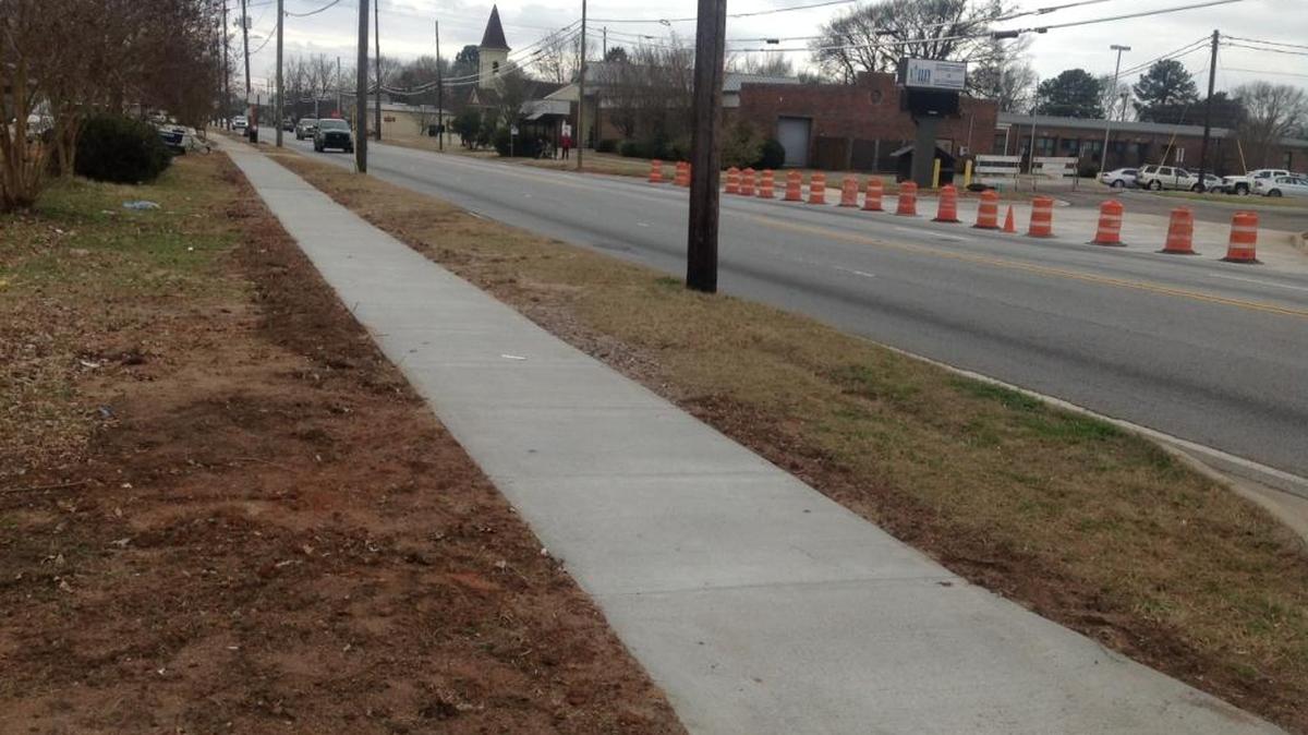 A contractor recently finished this section of new sidewalks in the 2900 block of Second Avenue in Columbus. Some claim the road needs attention too.