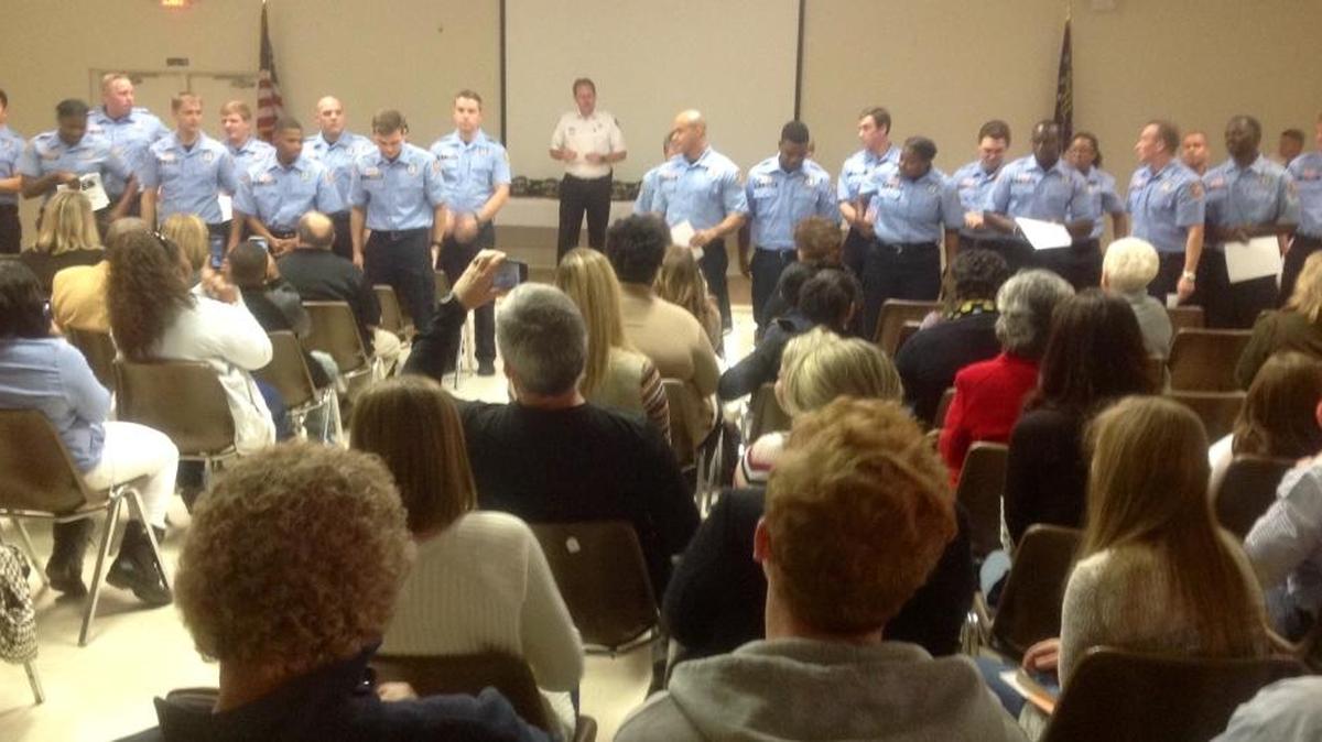 Cadets stand at their graduation Friday, turn and acknowledge those in the audience who came to see them be sworn in as firefighters and EMTs.