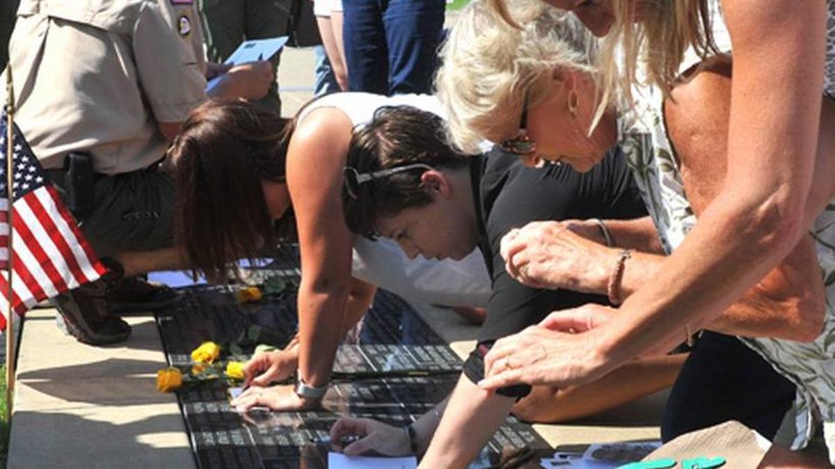 Visitors take photographs and etchings of loved ones’ pavers at the National Infantry Museum.