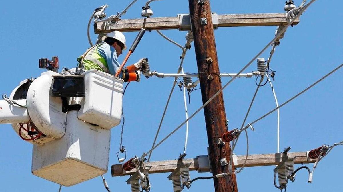 A Greenwood Utilities lineman works on power lines in Durant, Miss.