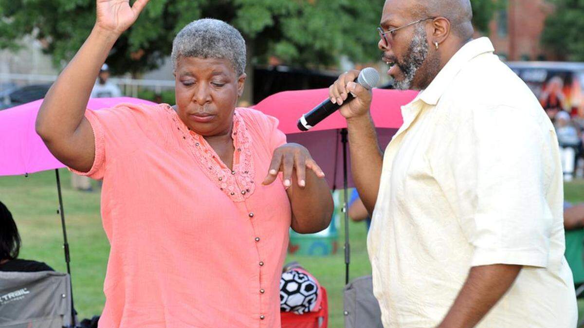 Alex Lattimore moving through the crowds at the Jazz on the River Concert and had to stop and sing for Patrice Dawson during the Jazz on the River Concert at Woodruff Riverfront Park Sunday August 28, 2016