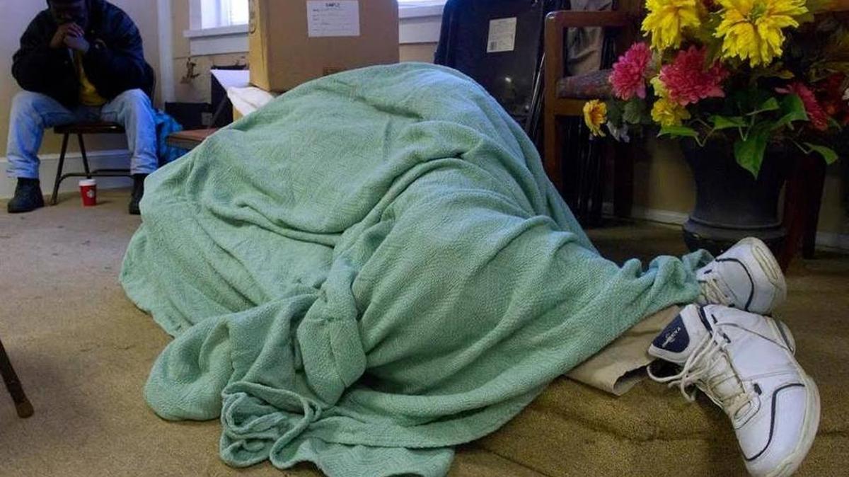 A homeless resident grabs some sleep at SafeHouse, one of the agencies that works with the homeless population.