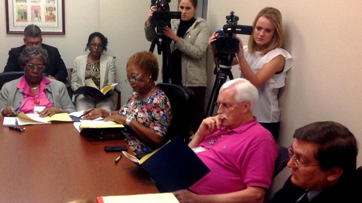 Uhland D. Roberts, second from right, reviews documents during a Muscogee elections board meeting.