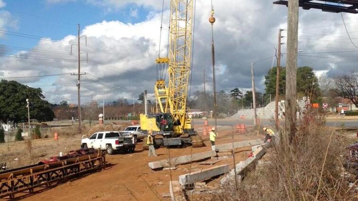 A crew with Southeastern Site Development Inc. of Newnan, Ga., was busy last week working on the foot bridge project across Victory Drive .