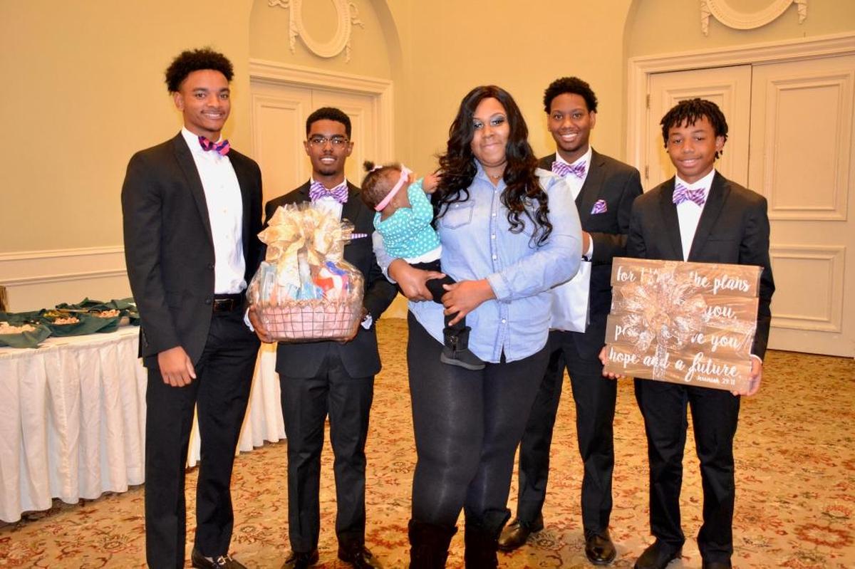 Beaux present gifts to Habitat Home recipient, Brandy Anderson, at a brunch and talent show held at Green Island Country Club. Pictured, from left to right, are Robbie Tillman, Jerry Santiago, Brandy Anderson (recipient), Bryce Boston and Garrek Fuller.