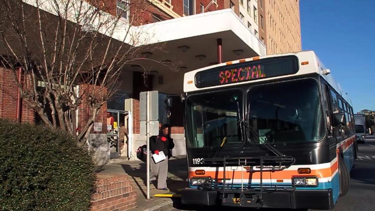 A Ralston resident boards a METRA bus to be taken to an area hotel after the building's heating system faltered, leaving most rooms without heat as overnight lows have dropped below freezing.