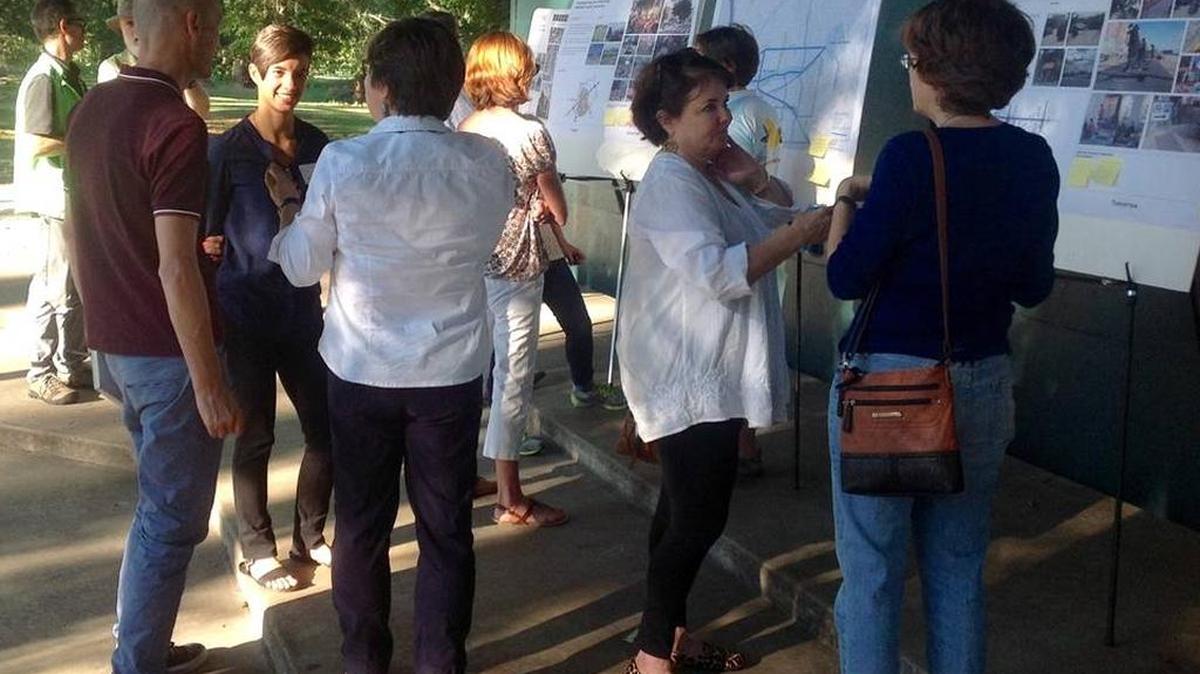 Gehl planners Julia Day, facing camera, and Andreas Rohl, to her right, speak to residents about the “Minimum Grid” draft proposal at Lakebottom Park in 2015. The Minimum Grid idea was one of the first Knight Cities Challenge ideas to be approved for Columbus.