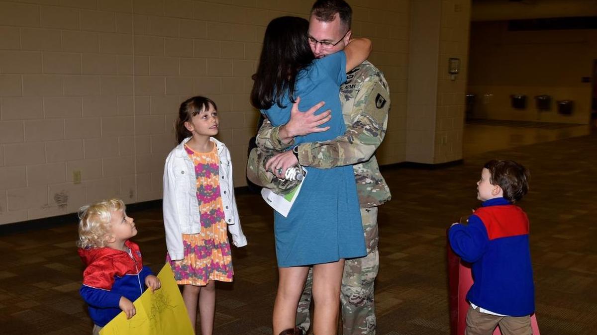 Major Kevin Kirchgraber is greeted by his wife Laura and their children, Kara, Colin and Brendan.
