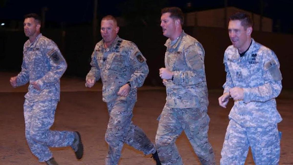 Maj. Casey Galligan, from left, Command Sgt. Maj. Tomothy Metheny, Acting Secretary of the Army Patrick J. Murphy and Maj. Gen. Eric Wesley go through PT Monday morning at Fort Benning.