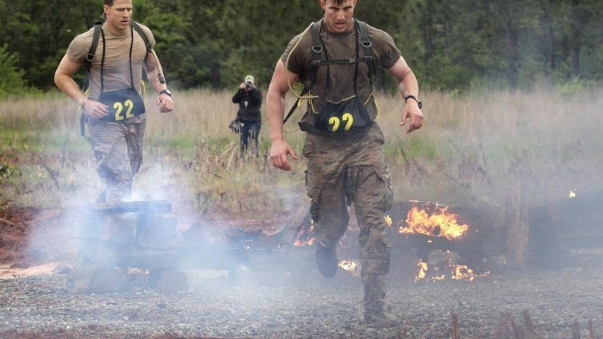 1st Lt. Matthew Linarelli, front, and teammate Capt. Michael White run through the smoke and fire obstacle to finish the Spartan Race Saturday, part of day two of Best Ranger competition. The soldiers are with the 101st Airborne Division.