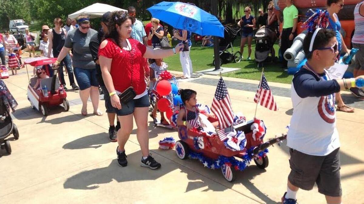 The Guzmans of Phenix City walk away with first place during the parade at the National Infantry Museum on Monday.