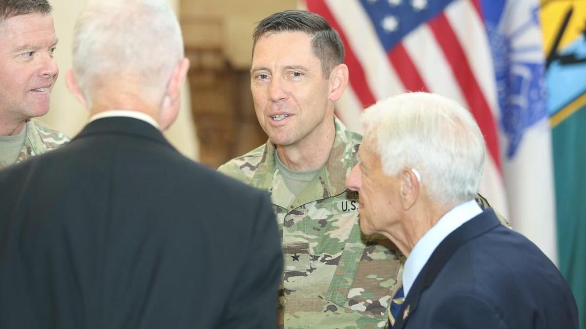 Gen. David Perkins, left, retired Gen. Edwin H. Burba, back to camera, Maj. Gen. Eric J. Wesley and retired Lt. Gen. Carmen Cavezza talk at Wesley’s promotion ceremony Monday at Fort Benning.